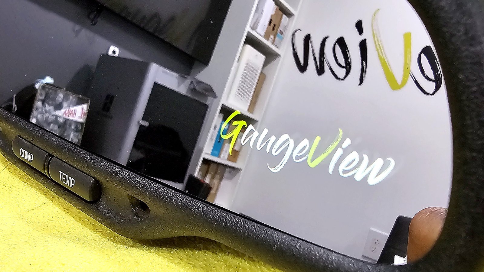 A GaugeView build: two live gauges glowing inside a factory rearview mirror